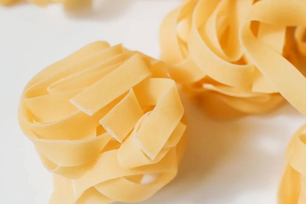 assorted dried Italian pasta spaghetti penne fusilli farfalle arranged beautifully